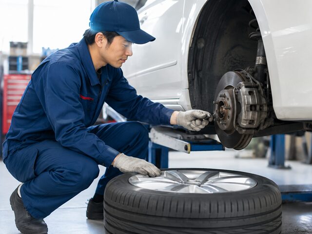 整備士が車のタイヤ交換中